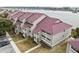 Aerial view of waterfront property with multiple buildings and parking at 48 Mariners Cay Dr, Folly Beach, SC 29439