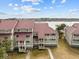 Waterfront property featuring multiple buildings with red roofs and a waterway at 48 Mariners Cay Dr, Folly Beach, SC 29439