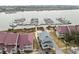 Aerial view of waterfront property, including a unique gray roofed building at 48 Mariners Cay Dr, Folly Beach, SC 29439