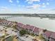Aerial view of a waterfront community, showcasing buildings and parking at 48 Mariners Cay Dr, Folly Beach, SC 29439