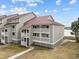 Two-story building with gray siding, red roof, and water views at 48 Mariners Cay Dr, Folly Beach, SC 29439