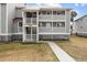 Two-story building with gray siding and a red metal roof at 48 Mariners Cay Dr, Folly Beach, SC 29439