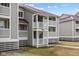 Gray building with white railings and stairs leading to the entrance at 48 Mariners Cay Dr, Folly Beach, SC 29439