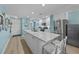 Modern kitchen with white cabinetry, granite island, and stainless steel appliances at 48 Mariners Cay Dr, Folly Beach, SC 29439