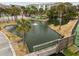 Serene pond with wooden footbridge and kayaks at 48 Mariners Cay Dr, Folly Beach, SC 29439