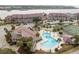 Community pool and surrounding area with palm trees and tennis court at 48 Mariners Cay Dr, Folly Beach, SC 29439
