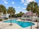 Community pool with palm trees and clubhouse at 48 Mariners Cay Dr, Folly Beach, SC 29439