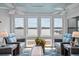 Sunroom with wicker furniture and stunning water views at 48 Mariners Cay Dr, Folly Beach, SC 29439