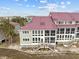 Townhome with screened porch and stairs leading to waterfront at 48 Mariners Cay Dr, Folly Beach, SC 29439