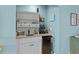 Small wet bar with a sink, beverage cooler, and storage at 48 Mariners Cay Dr, Folly Beach, SC 29439