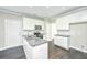 Modern kitchen with white cabinets, stainless steel appliances, and a large island at 4801 Little School Ct, Summerville, SC 29485