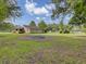 Large backyard with fire pit and trees at 506 Gross Ave, Moncks Corner, SC 29461