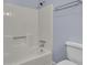Bathroom with white tub and shower, and light-blue walls at 506 Gross Ave, Moncks Corner, SC 29461