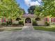 Tan house with red roof, arched entryway, and landscaped yard at 506 Gross Ave, Moncks Corner, SC 29461