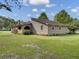Tan house with red roof and large yard at 506 Gross Ave, Moncks Corner, SC 29461