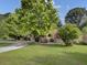 House exterior with red shutters and a large tree in front at 506 Gross Ave, Moncks Corner, SC 29461