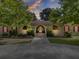 Tan house with red accents, landscaping, and a long driveway at 506 Gross Ave, Moncks Corner, SC 29461