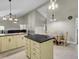Kitchen with island, granite countertop, and beige cabinets at 506 Gross Ave, Moncks Corner, SC 29461