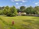 Large grassy side yard with detached garage and wooden fence at 506 Gross Ave, Moncks Corner, SC 29461