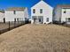 Spacious backyard with two-story home and black metal fence at 515 Purple Finch Rd, Summerville, SC 29486