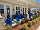 Relaxing community clubhouse porch with blue Adirondack chairs at 515 Purple Finch Rd, Summerville, SC 29486