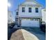 Two-story white house with gray brick accents, two-car garage, and landscaping at 515 Purple Finch Rd, Summerville, SC 29486