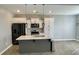Modern kitchen with white cabinets, island, and stainless steel appliances at 515 Purple Finch Rd, Summerville, SC 29486
