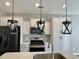 Modern kitchen with white cabinets and unique lighting at 515 Purple Finch Rd, Summerville, SC 29486