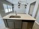 Modern kitchen island with quartz countertop, stainless steel sink, and dishwasher at 515 Purple Finch Rd, Summerville, SC 29486