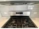 Stainless steel gas range with modern controls and white tile backsplash at 515 Purple Finch Rd, Summerville, SC 29486