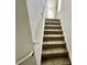 Carpeted staircase with neutral colored walls and simple railing at 515 Purple Finch Rd, Summerville, SC 29486