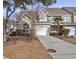 Attractive 2 story townhome with a tan and brick exterior, a driveway, and landscaping at 5211 Fernland Way, North Charleston, SC 29420