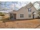 Tan house with screened porch, pond view, and mature trees at 5211 Fernland Way, North Charleston, SC 29420