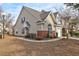 Tan house with brick accents and attached garage at 5211 Fernland Way, North Charleston, SC 29420
