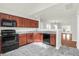 Modern kitchen with dark wood cabinets, granite countertops and black appliances at 5211 Fernland Way, North Charleston, SC 29420