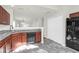 Modern kitchen with dark wood cabinets, granite countertops and black appliances at 5211 Fernland Way, North Charleston, SC 29420