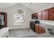 Modern kitchen features granite countertops, stainless steel appliances, and an arched window at 5211 Fernland Way, North Charleston, SC 29420