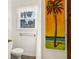 Small bathroom with shower, toilet, and tropical artwork at 609 Palmetto Blvd, Edisto Beach, SC 29438