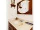 Clean bathroom with a vanity, sink, and antique mirror at 609 Palmetto Blvd, Edisto Beach, SC 29438