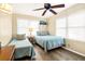 Cozy bedroom with two twin beds and ceiling fan at 609 Palmetto Blvd, Edisto Beach, SC 29438