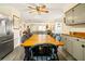 Kitchen dining area with a long wooden table and six chairs at 609 Palmetto Blvd, Edisto Beach, SC 29438