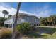 Elevated beach home with deck, lush landscaping, and private setting at 609 Palmetto Blvd, Edisto Beach, SC 29438