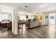 Open living area with gray sofa and view into bedroom and bathroom at 609 Palmetto Blvd, Edisto Beach, SC 29438