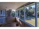 Screened porch with view of palm trees and yard at 609 Palmetto Blvd, Edisto Beach, SC 29438