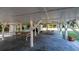 Under house area with concrete slab, picnic tables, and ample storage at 609 Palmetto Blvd, Edisto Beach, SC 29438