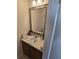 Clean bathroom with a vanity, sink, and a large framed mirror at 6884 Shahid Row, North Charleston, SC 29418