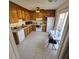 Bright kitchen with wood cabinets, tiled floor, and access to backyard at 6884 Shahid Row, North Charleston, SC 29418
