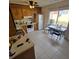 Cozy kitchen featuring wood cabinets, tile floor, and patio access at 6884 Shahid Row, North Charleston, SC 29418