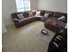 Spacious living room featuring a large sectional sofa and tile flooring at 6884 Shahid Row, North Charleston, SC 29418