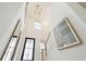 Two-story entryway with hardwood floors, a chandelier, and art at 729 Opal Wing St, Moncks Corner, SC 29461